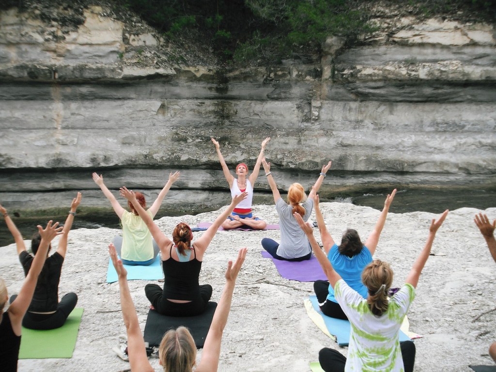 Women share a meditation session in a natural setting